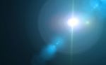 Beautiful Blue Digital Lens Flare In Black Background Horizontal Frame Stock Photo