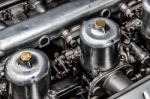 Carburettors Under The Bonnet Of An Old Jaguar Sports Car Stock Photo