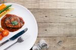 Beef Steak In Dish On Wood Table Stock Photo