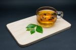 Clear Glass Of Tea And Tea Leaves On Wooden Plate Isolated On Bl Stock Photo