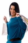 Side Pose Of Smiling Model With Carry Bags On White Background Stock Photo