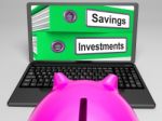 Savings And Investments Files On Laptop Showing Finances Stock Photo