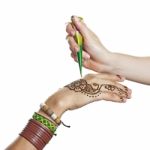 The Process Of Applying Mehendi On A Woman's Hand Stock Photo