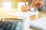 Businessman And Estate Agent Signing A Document For House Deal, Stock Photo