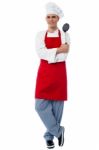 Young Chef Posing In Style With Kitchen Utensils Stock Photo