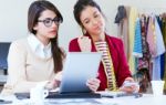 Two Young Businesswomen Working With Digital Tablet In Her Offic Stock Photo