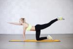 Young Woman Stretching Before Fitness Exercises On A Mat In A Gy Stock Photo