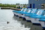 View Of Blue Boats For Hire At Potter Heigham Stock Photo