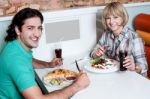 Young Smiling Couple Enjoying Meals Stock Photo