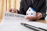 A Young Man In Suit In His Office Showing An Insurance Policy An Stock Photo