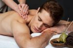 Man Getting Relaxing Massage In Spa Stock Photo