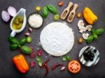 The Ingredients For Homemade Pizza On Dark Stone Background Stock Photo