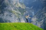 A Woman Ready To Go Down From Hill By Kick Scooter At Bort Stati Stock Photo