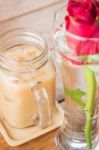 Iced Milk Coffee Serving On Wooden Table Stock Photo