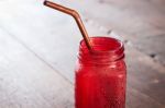 Iced Drink In Red Glass On Wooden Table Stock Photo