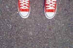 Feet Concept With Red Sneakers On Black Background With Space For Text Or Symbol. Vintage Tone Stock Photo