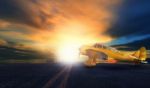 Old Yellow Propeller Plane On Airport Runway With Sunset Sky Background Stock Photo