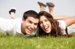 Playful Young Couple Laying Down Stock Photo