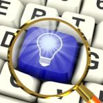 Light Bulb Key Magnified Means Bright Idea Innovation Or Inventi Stock Photo