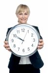 Business Executive Displaying Big Wall Clock Stock Photo