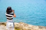 Young Woman Photography Near The Sea Stock Photo