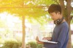 Asian Teenager Using Laptop  Stock Photo