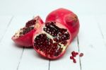 Fresh Pomegranate Fruits Isolated On A White Wooden Background Stock Photo