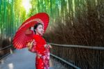 Bamboo Forest. Asian Woman Wearing Japanese Traditional Kimono At Bamboo Forest In Kyoto, Japan Stock Photo