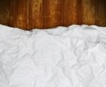 White Crumpled Paper On Wood  Stock Photo