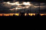 Wind Turbines And Electric Poles At Sunset Stock Photo