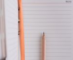 Business Notebook And Brown Pencil Stock Photo