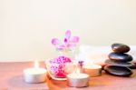 Spa Composition With Candle, Pebbles And Aroma Oil Stock Photo