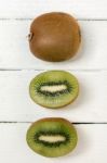 Tasty Kiwi Fruits Isolated On A White Wooden Background Stock Photo