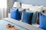 Blue Pillow On Bed With Glasses On Cloth In Modern Bedroom Stock Photo