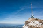 Broadcast / Radio Mast On The Top Of The Mountain Rigi With A Mountain Rail And A Blue Background Stock Photo