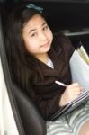 Little Business Girl Writing Something In Her Car Stock Photo