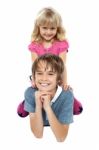 Adorable Sister Sitting On Her Brothers Back Stock Photo