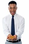 Young Male Executive Holding Gold Coins Stock Photo