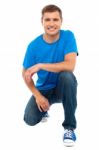 Smiling Man With Kneeling Down Stock Photo