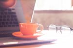 Coffee Cup With Keyboard On Wooden Table Stock Photo