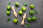 Fresh Limes And Wooden Juicer On White Background. Top View Stock Photo