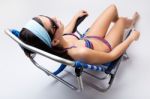 Beautiful Young Woman With Bikini Sitting On A Beach Chair Stock Photo