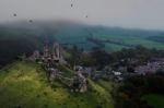 Old Castle In Ruins On Top Of Hill With Foggy Weather Stock Photo