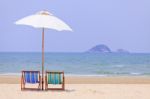 Beach Chairs And White Umbrella Stock Photo