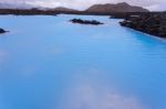 Milky White And Blue Water Between The Lava Stones Covered With Moss Stock Photo