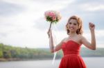 Beautiful Woman Wear Red Evening Dress Hold A Bouquet Of Flowers Stock Photo