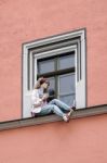 Mannequin Sitting On A Windowledge In Weimar Stock Photo