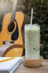 Matcha Tea With Milk On Creative Work Table Stock Photo