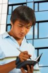 Man Writing In His Organizer Stock Photo