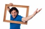 Excited Man Holding Picture Frame Stock Photo